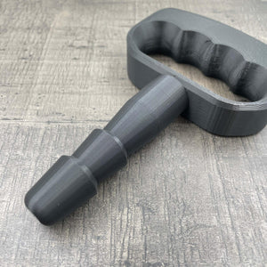 Een adapter voor vac-u-lock seks toys met een zwarte handgreep.