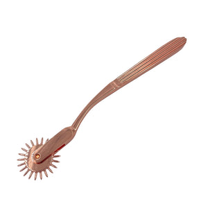 A wartenberg pinwheel for BDSM in rose-gold