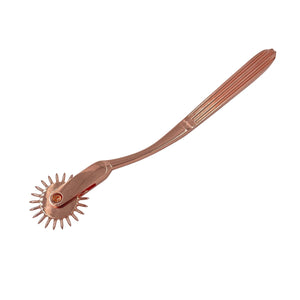 A wartenberg pinwheel for BDSM in rose-gold