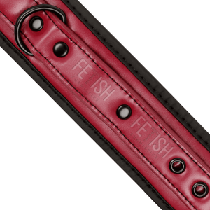 Detail shot of a BDSM ankle cuffs made from vegan leather in red and black colour