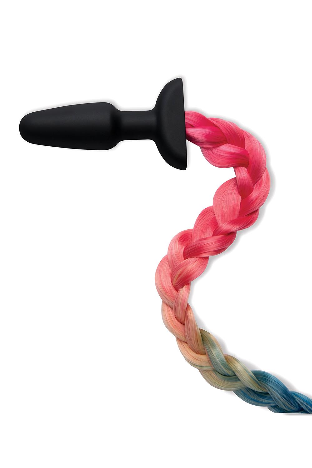 A black butt plug with a tail in rainbow colors