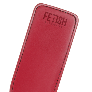 Detail shot of a vegan leather paddle for BDSM in red