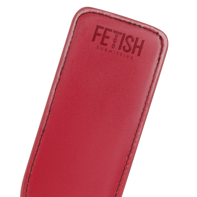 Detail shot of a vegan leather paddle for BDSM in red